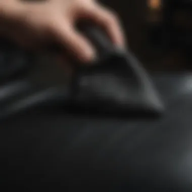 Application of leather conditioner on a black leather seat using a soft cloth