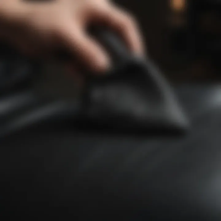 Application of leather conditioner on a black leather seat using a soft cloth