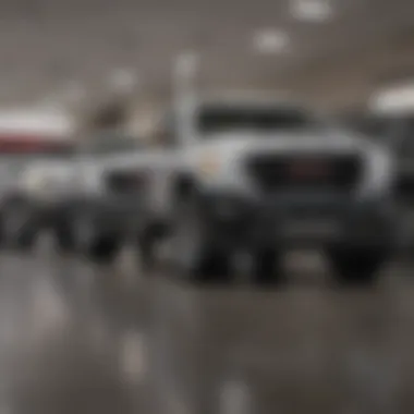 Interior view of a GMC dealership with a diverse vehicle lineup